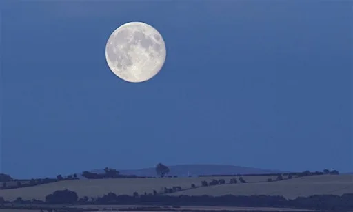 A Harvest Moon lights up the landscape